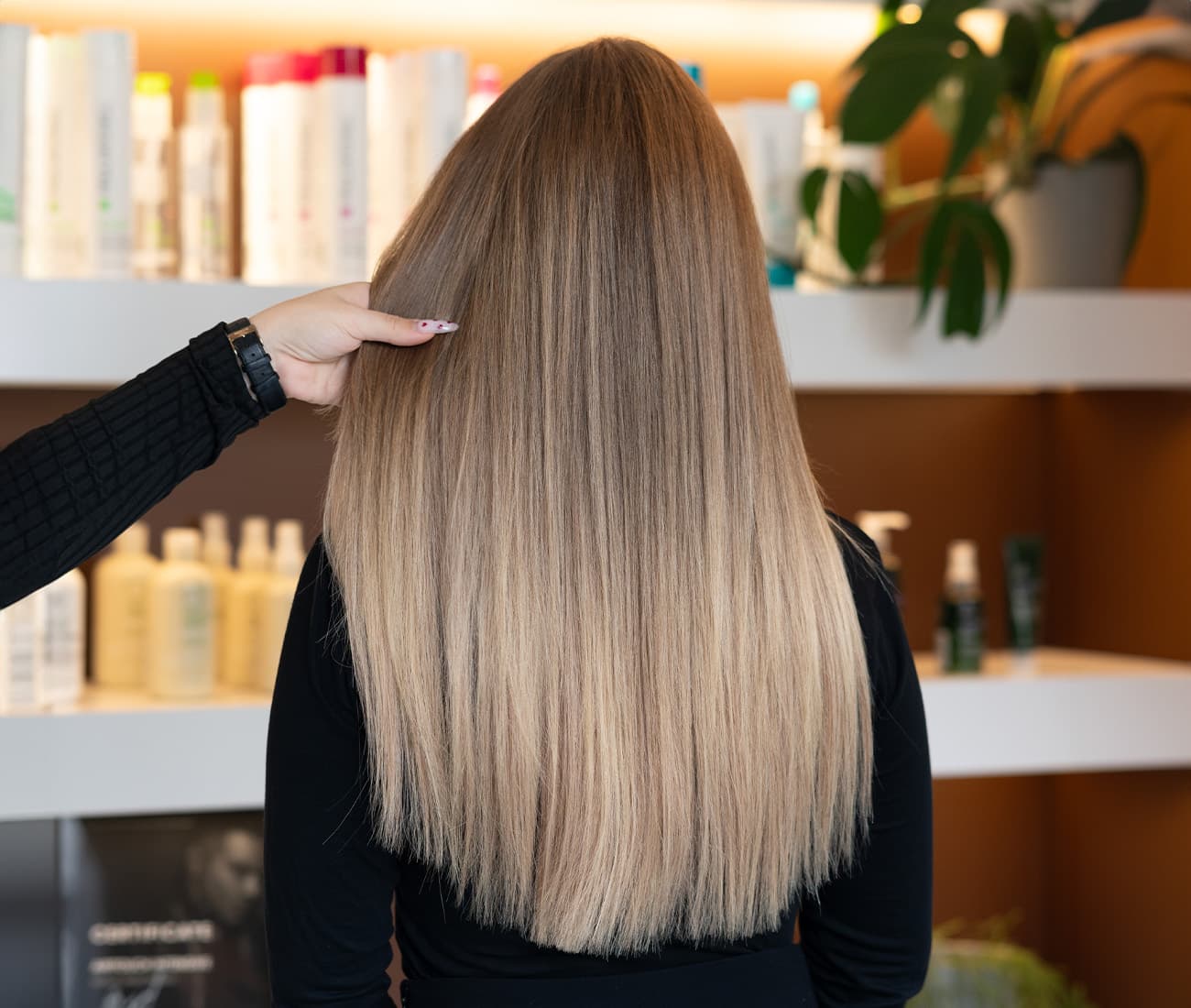 Friseur trägt Farbe mit der Airtouch Balayage Technik auf